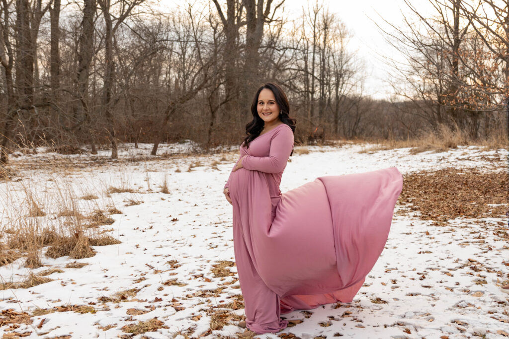 A pregnant woman posing for a photo at Cross Estate Gardens in Bernardsville, New Jersey. 