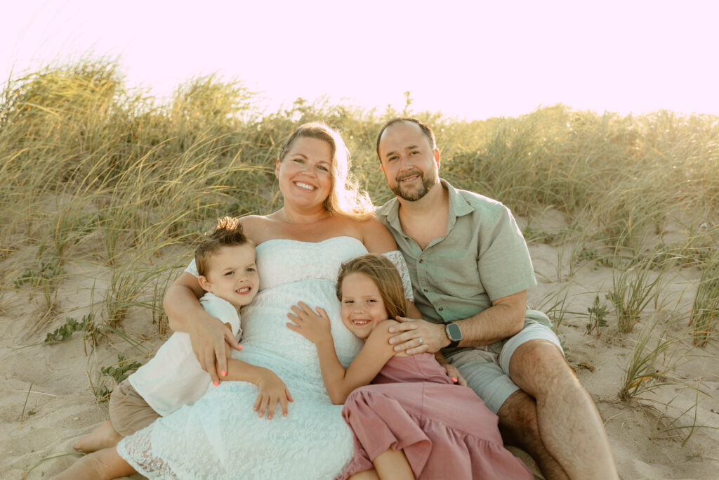 A family posing for a photoshoot at Sandy Hook Beach in New Jersey. 