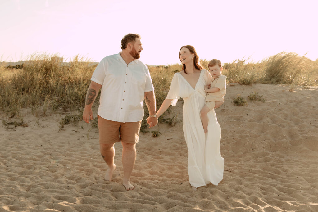 A family walking on Sandy Hook Beach in New Jersey.