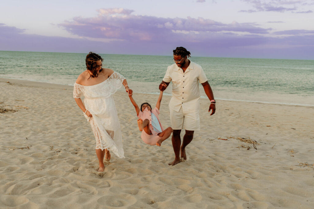 A family walking on the beach at Sandy Hook New Jersey. 