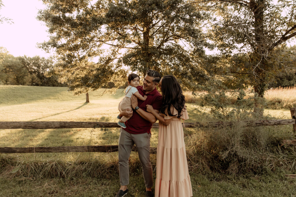 a family posing for a fall family photo session at Lenape Park in Cranford New Jersey
