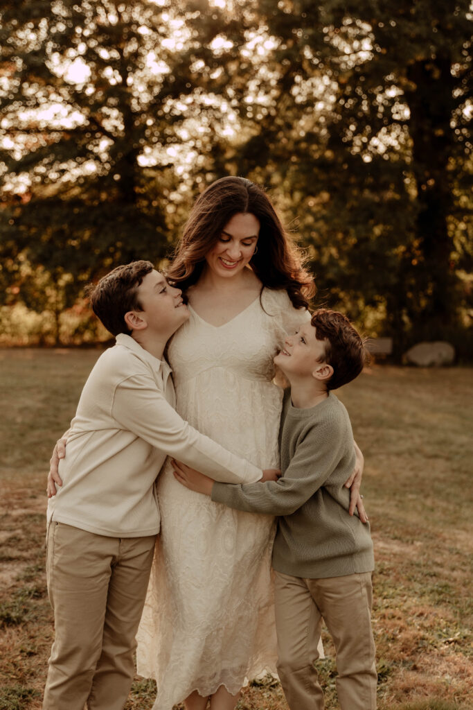 a family posing for a fall photo session in Oak Ridge Park in Clark New jersey