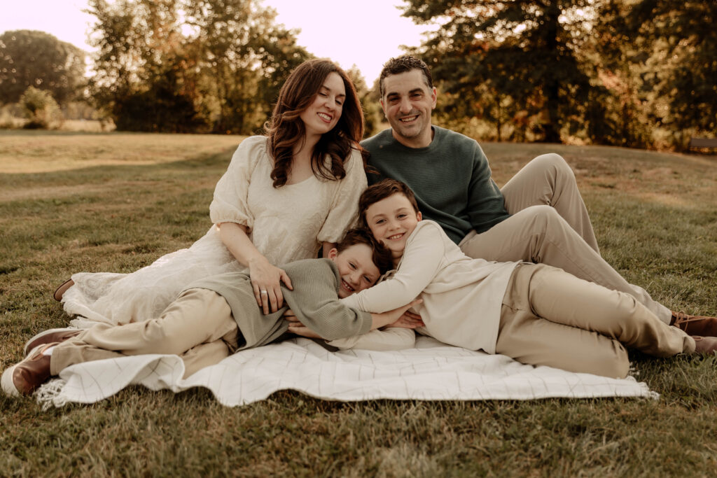 a family posing for a fall photo session in Oak Ridge Park in Clark New jersey