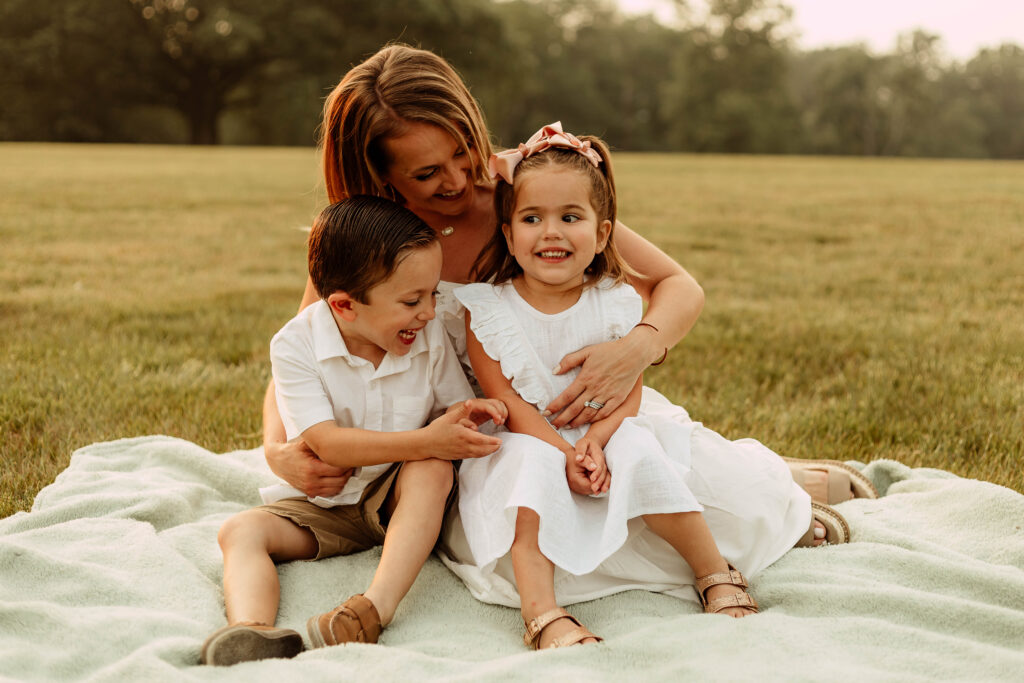 a mom and two kids posing for a photo at Colonial Park in Somerset New Jersey