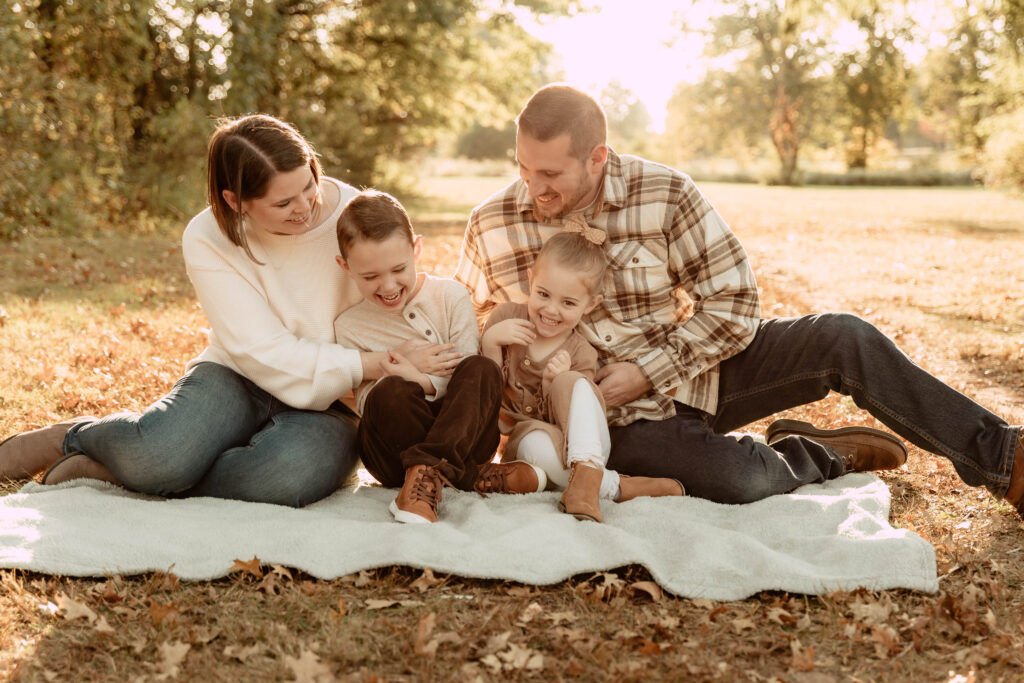 a family tickling each other during a fall family photo shoot in New Jersey