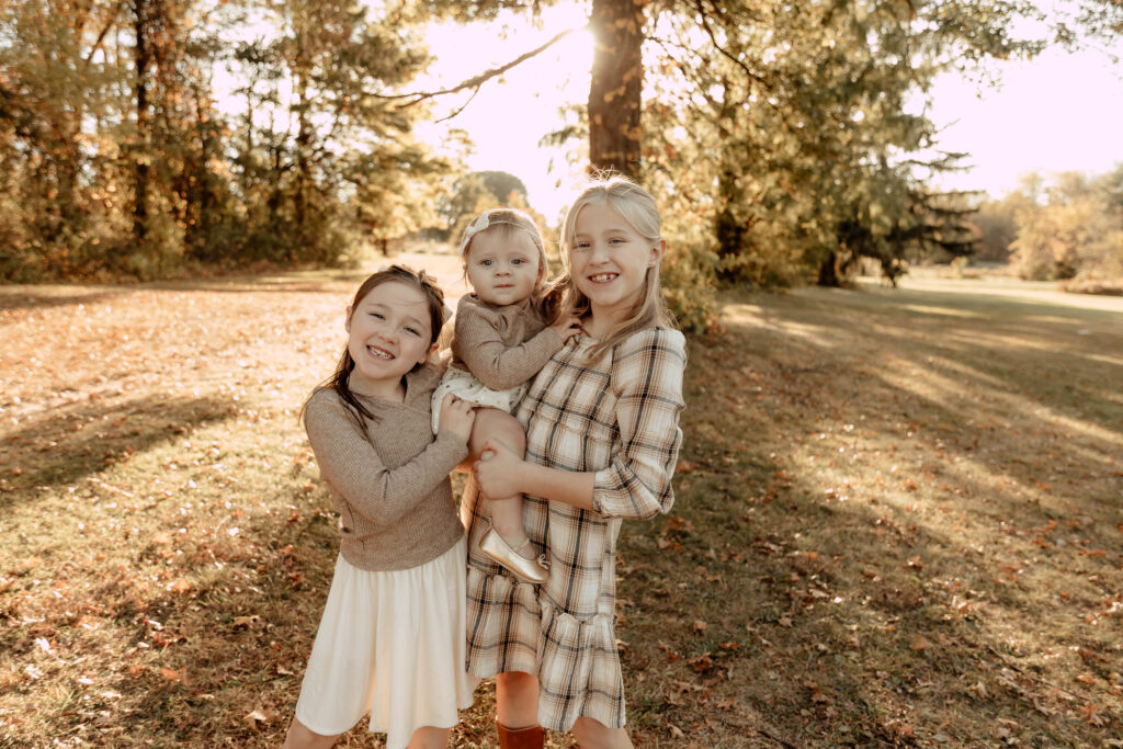 3 girls posing for a fall photo at a park in Union County, New Jersey