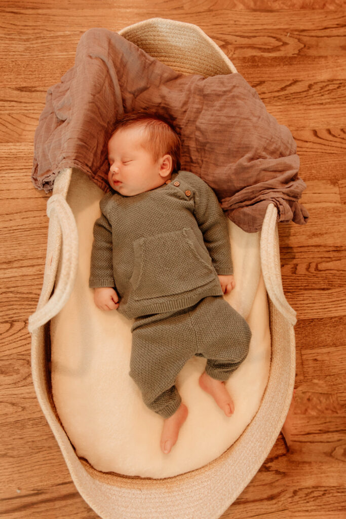a newborn boy posing for a newborn photo in a home in New Jersey