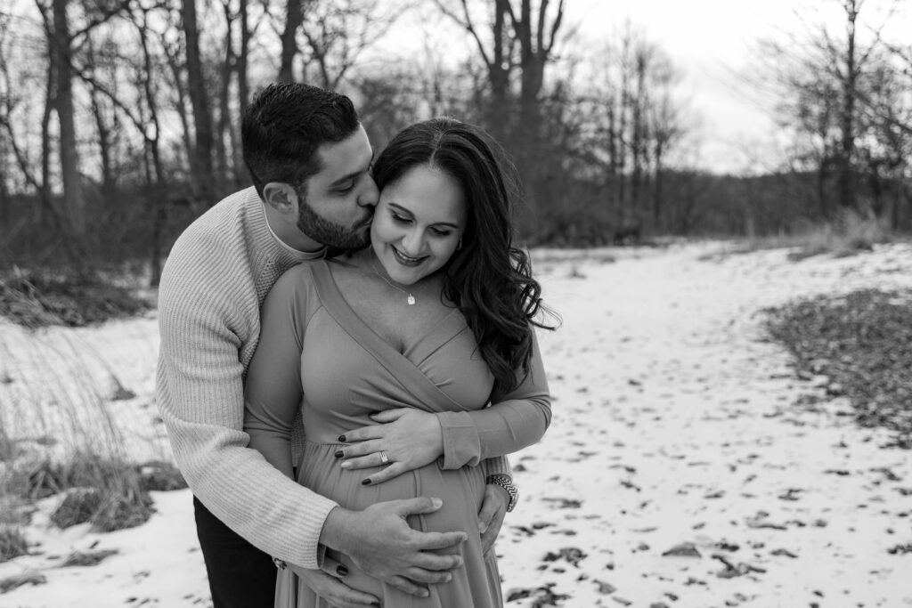 a photo of a couple posing during a winter maternity session in New Jersey. 