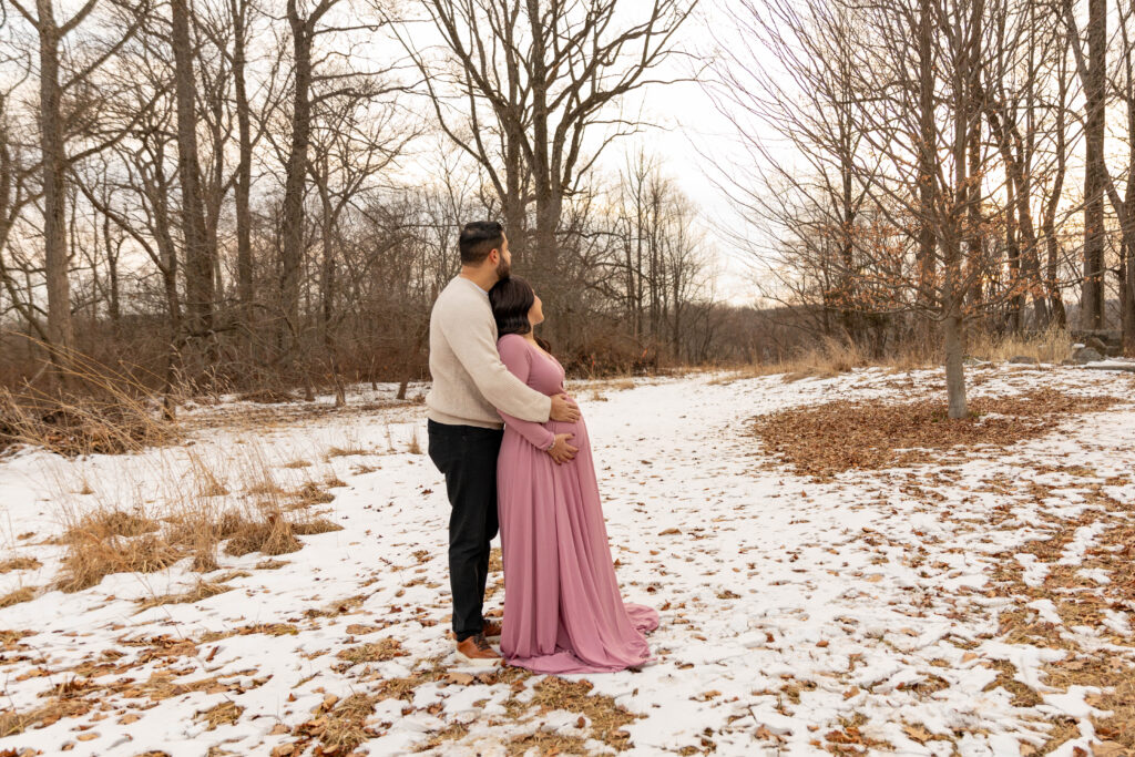 a photo of a couple posing during a winter maternity session in New Jersey. 