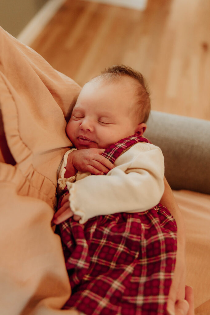 a newborn baby in her mother's arm during a newborn session in New Jersey