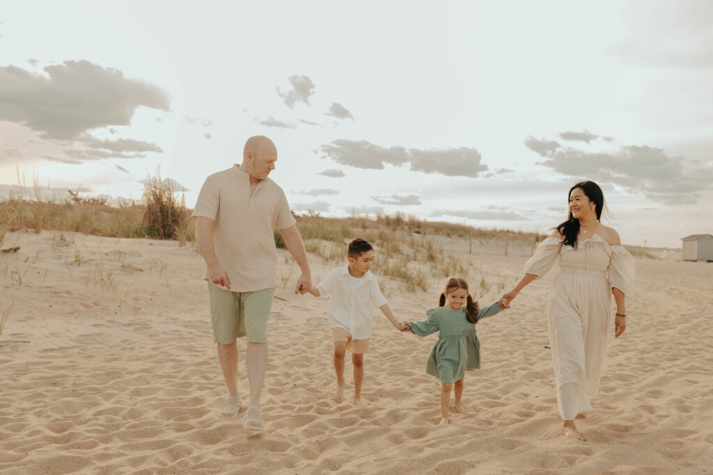 A family walking on the beach in Sandy Hook Beach, New Jersey.